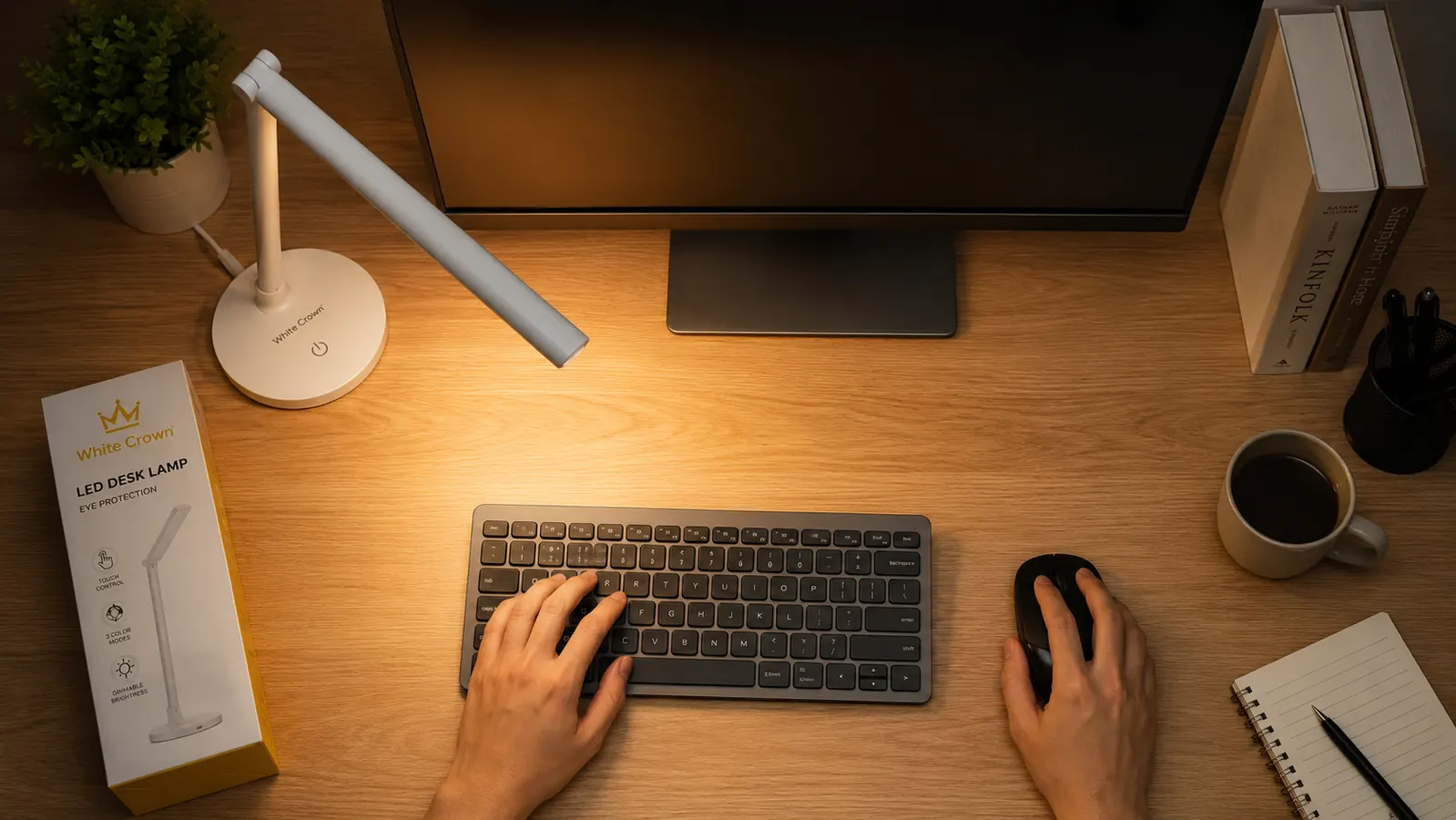 White Crown LED desk lamp positioned to the left of a monitor at 45 degrees, illuminating a keyboard without casting screen glare
