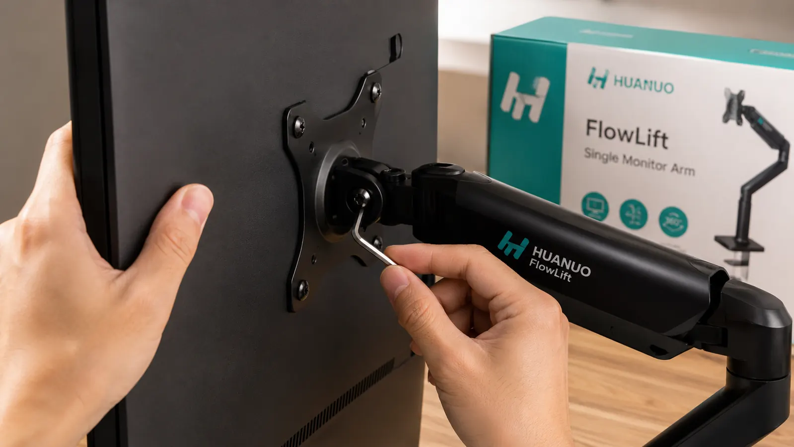 Close-up of hands tightening a hex bolt on a monitor arm VESA plate to adjust tilt tension